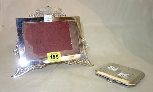 A silver rectangular photograph frame, with pierced surmount and wire work feet, (a.f), stamped London 1904, Mappin & Webb and a silver cut cornered c