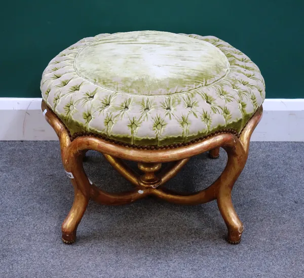 A Napoleon III gilt framed circular stool, on four shaped supports and stretchers, 58cm wide x 42cm high.