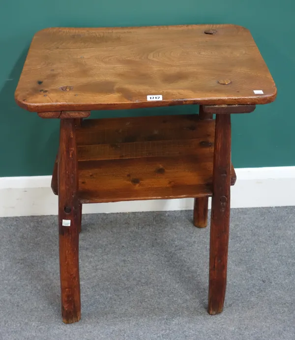 A George III primitive elm two tier table, on staked supports, 57cm wide x 67cm high x 45cm deep.