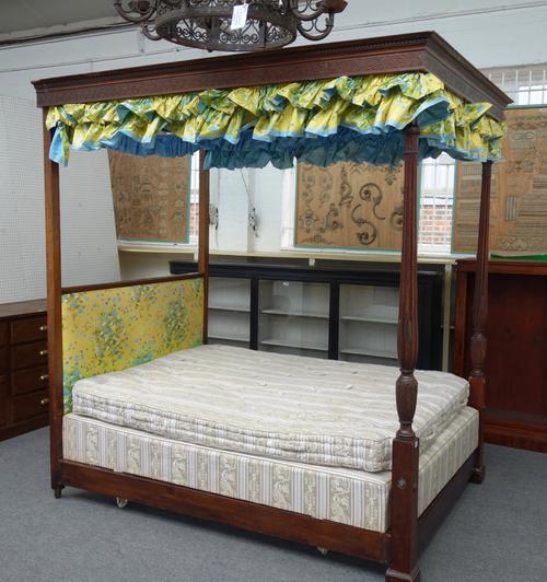 A William IV and later mahogany four poster bed, with blind fret carved canopy and baluster reeded supports, 219cm wide x 237cm high x 170cm deep.