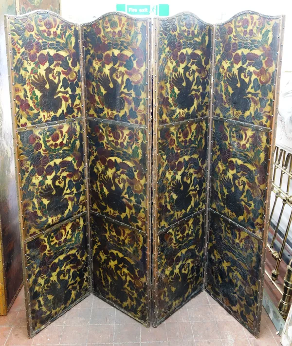 A late 19th century floral embossed polychrome painted arched top four fold draft screen, 204cm wide x 184cm high x 3cm deep.