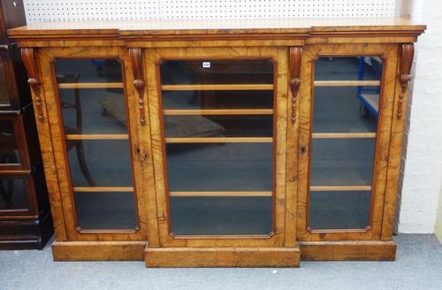 A Victorian figured walnut floor standing breakfront display cabinet, with three glazed doors, on plinth base, 185cm wide x 122cm high x 50cm deep.