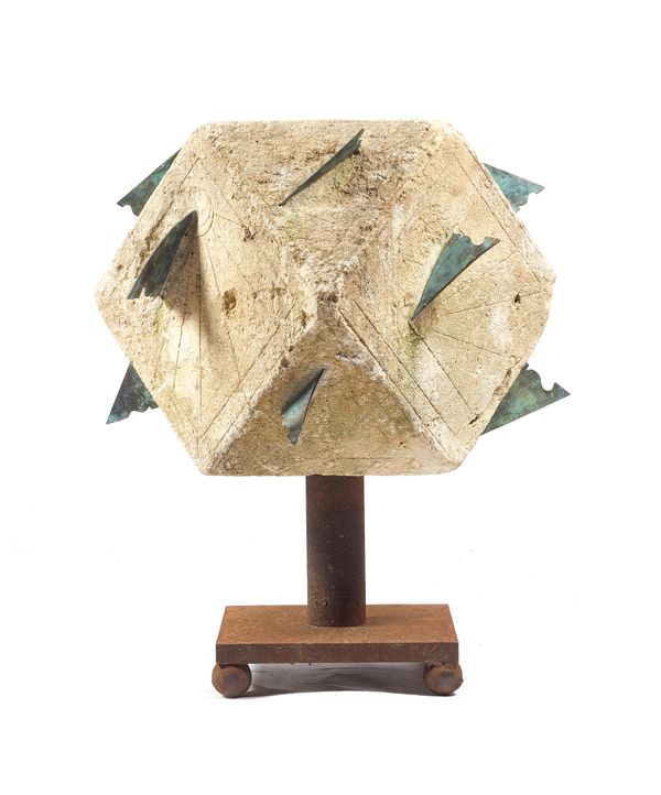 A large 18th century polyhedral limestone sundial, on a later cast iron stand, 65cm wide x 75cm high.  Illustrated
