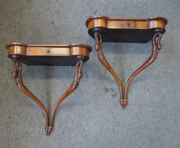 A pair of Continental mahogany wall mounted console tables, each with single frieze drawer and pair of swan head mounts, 51cm wide x 53cm high x 27cm