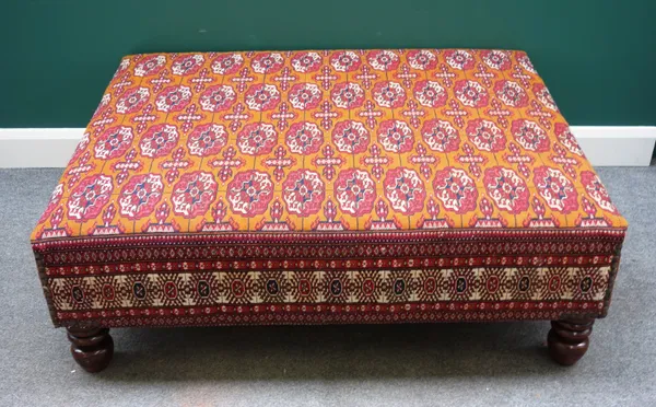 A large rectangular footstool in Turkman upholstery on turned feet, 129cm wide x 44cm high x 102cm deep.