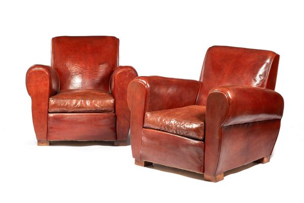 A pair of mid-20th century French brown leather upholstered armchairs, on block supports, each 85cm wide x 77cm high x 80cm deep, (2).  Illustrated