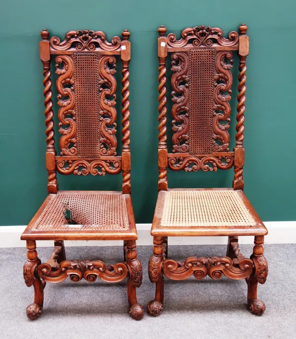 A pair of late 17th century walnut framed caned back and seat side chairs, 51cm wide x 126cm high x 54cm deep.