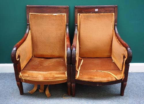 Gouffe, Paris; a pair of French Empire mahogany framed armchairs on sabre supports, (a.f.) ,64cm wide x 96cm high.