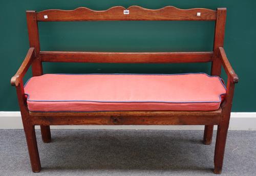 A 19th century North European oak settle with open back and arms, on block supports 119cm wide x 95cm high x 42cm deep.