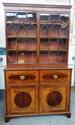 A George III inlaid mahogany secretaire cabinet, the pair of of glazed doors over fitted drawer and pair of cupboards on bracket feet, 131cm wide x 22