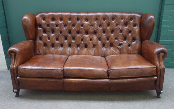 A mid-20th century studded brown leather upholstered three seat sofa, on pointed squat cabriole supports, 190cm wide x 95cm high x 80cm deep, together