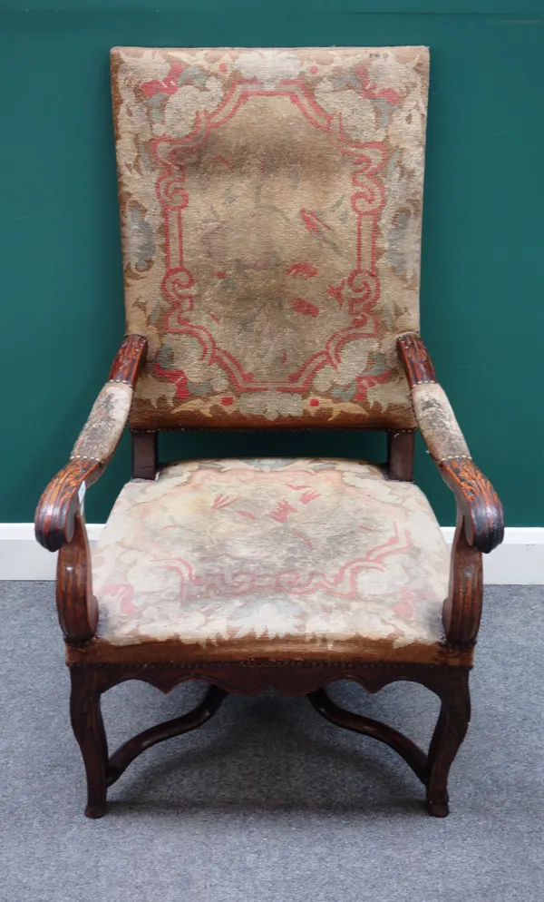 An early 19th century French carved oak open armchair on cabriole supports, 65cm wide x 116cm high x 75cm deep.