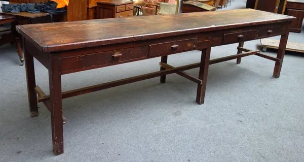 A large early 20th century pine haberdashery table with four frieze drawers on block supports and stretchers, 346cm wide x 91cm high x 75cm deep.