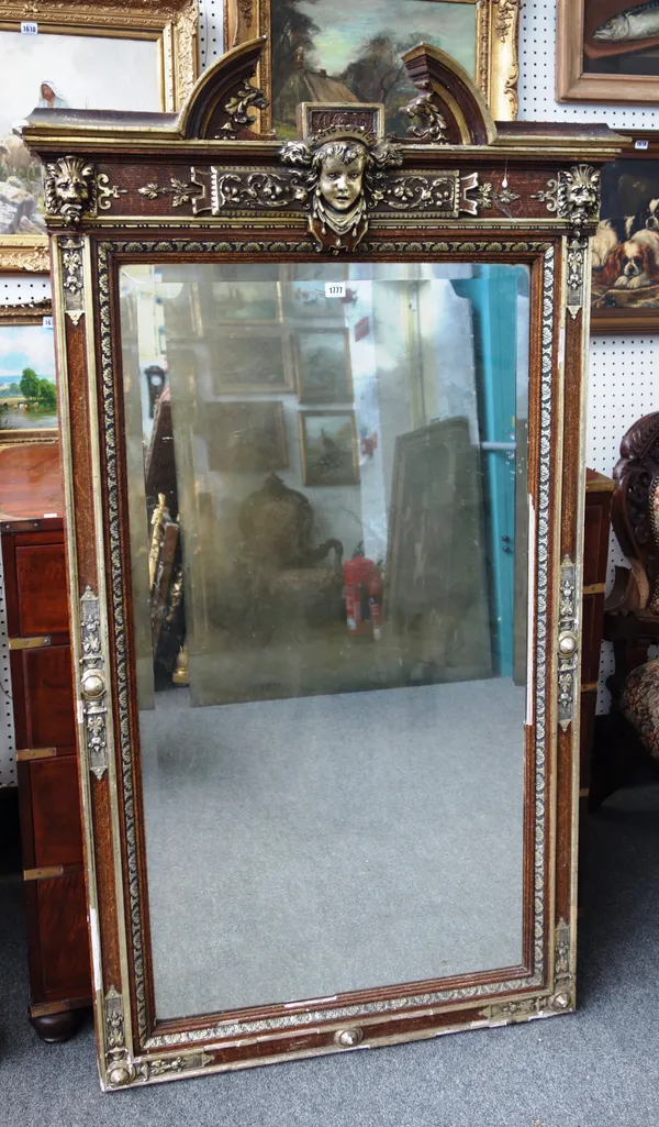 An early 20th century parcel gilt rectangular wall mirror, with broken arch cornice over the bevelled rectangular plate, 96cm wide x 170cm high.