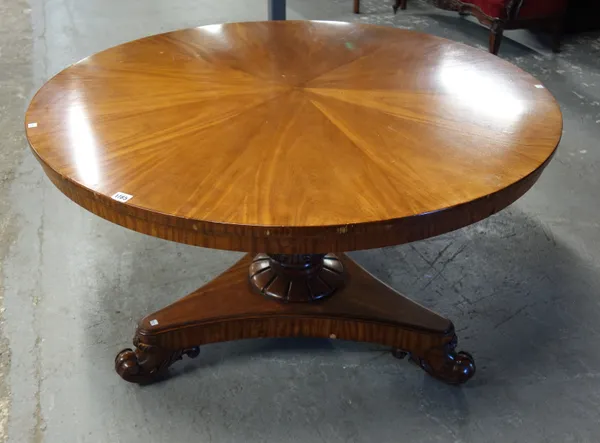 An early Victorian satinwood centre table, with radial veneered circular snap top, carved column and triform base, 121cm wide x 71cm high.