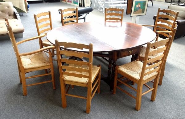 A set of eight light oak Lancashire style wavy ladder back dining chairs, to include a pair of carvers, (8).