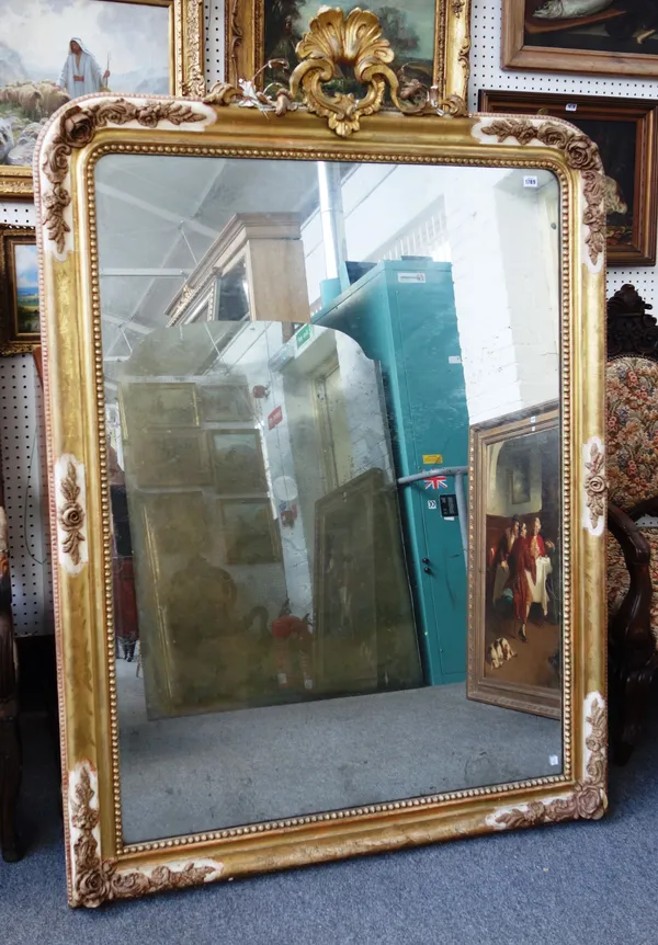 A 19th century gilt and cream framed arch top overmantel mirror, with opposing 'C' scroll crest and floral moulded frame, 121cm wide x 174cm high.