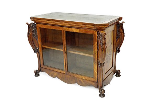 A mid-Victorian figured walnut free standing display cabinet/bookcase with leather inset shaped rectangular top over opposing pairs of glazed doors, t
