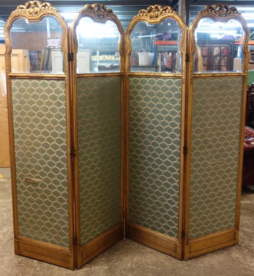 In the manner of Sue et Mare; an early 20th century French gilt framed semi glazed four fold arch top draft screen, 224cm wide x 199cm high x 3cm deep