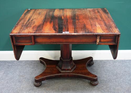 In the manner of William Trotter; a Regency coromandel sofa table, with single frieze drawer on octagonal column and quatrefoil platform, 95cm wide x