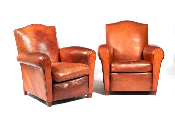 A pair of mid-20th century French tan leather upholstered club arm chairs on tapering square supports, 77cm wide x 81cm high x 80cm deep.  Illustrated