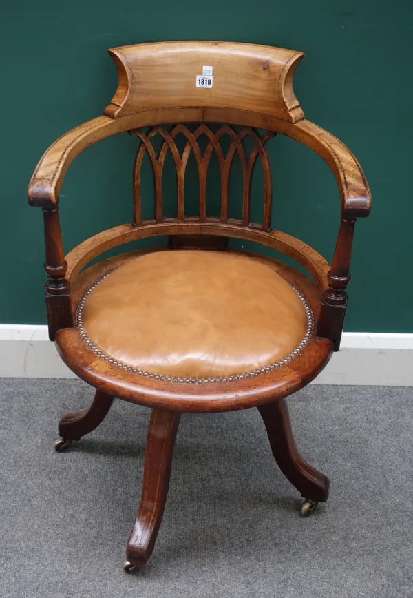A late 19th century inlaid mahogany tub back office swivel chair, with Gothic arch interlaced back, 56cm wide x 83cm high.