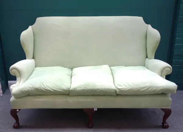 A Queen Anne style green wing back sofa on claw and ball feet, 187cm wide x 114cm high x 87cm deep.