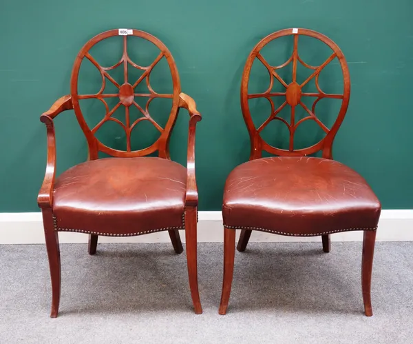 A set of six early 20th century spiderweb backed mahogany framed dining chairs, with serpentine seats and splayed supports, to include a pair of carve