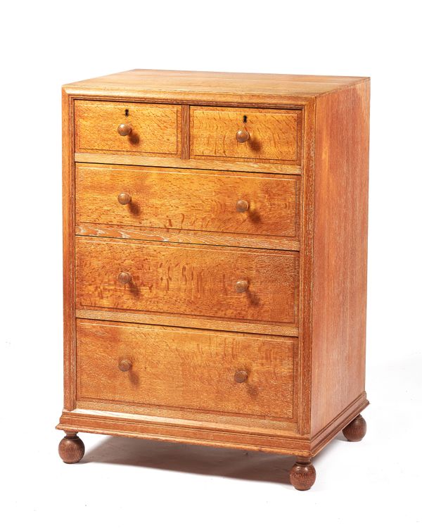 Probably Heals, a mid-20th century oak chest with two short and three long graduated drawers on bun feet, 61cm wide x 91cm high x 46cm deep.  Illustra
