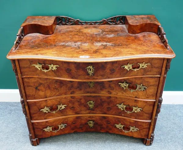 A Victorian figured walnut opposing serpentine chest of four long drawers flanked by canted carved columns, 101cm wide x 88cm high x 55cm deep.