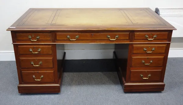An early 20th century mahogany pedestal desk, with nine drawers about the knee, on a plinth base, 154cm wide x 75cm high x 81cm deep.