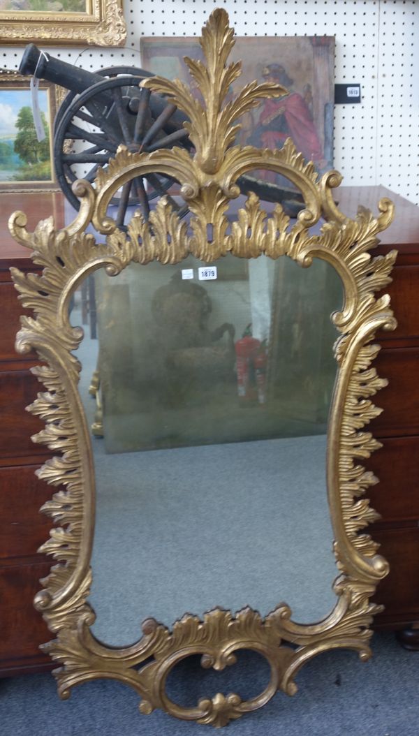 A George III style Rococo Revival gilt framed wall mirror, with opposing 'C' scroll upper and lower frieze, 71cm wide x 140cm high.