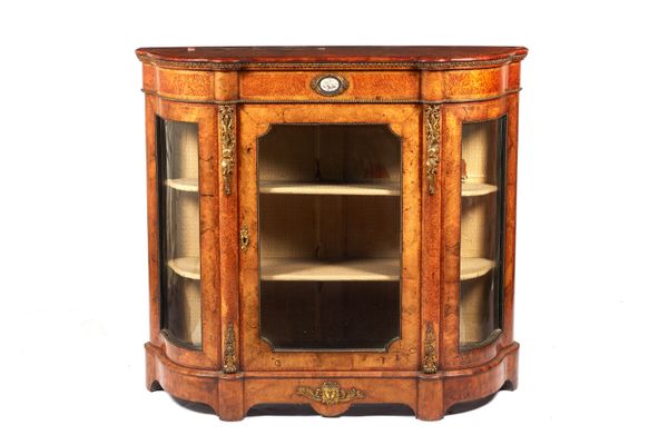 A Victorian gilt metal mounted figured walnut and amboyna credenza, with glazed central door flanked by rounded glazed doors, on plinth base, 123cm wi