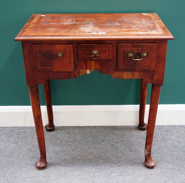 A mid-18th century figured walnut lowboy, with three frieze drawers on club supports, 69cm wide x 74cm high x 43cm deep.