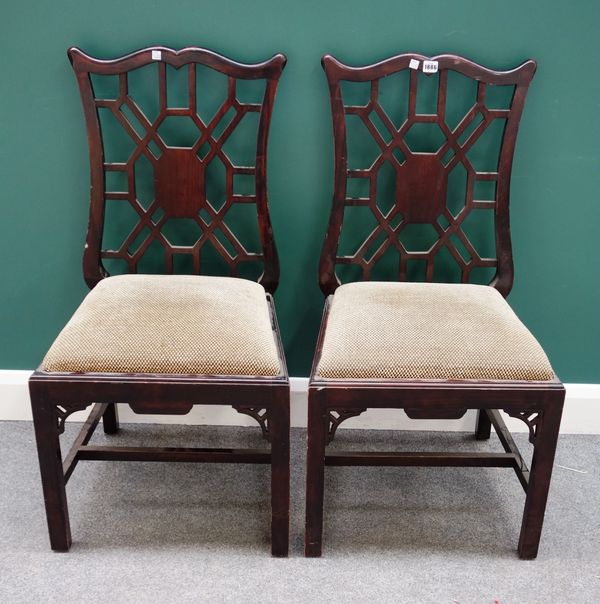 A pair of Chinese Chippendale style mahogany framed side chairs, with cockpen backs on block supports, 52cm wide x 98cm high x 48cm deep.