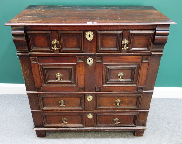 A late 17th century oak chest, of four long geometric moulded drawers on stile feet, 107cm wide x 107cm high x 55cm deep.