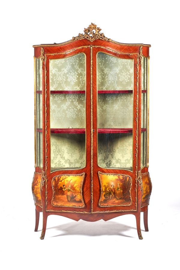 A Louis XV style gilt metal mounted mahogany display cabinet, the pair of serpentine glazed doors and shaped sides over four bombe vernis martin panel