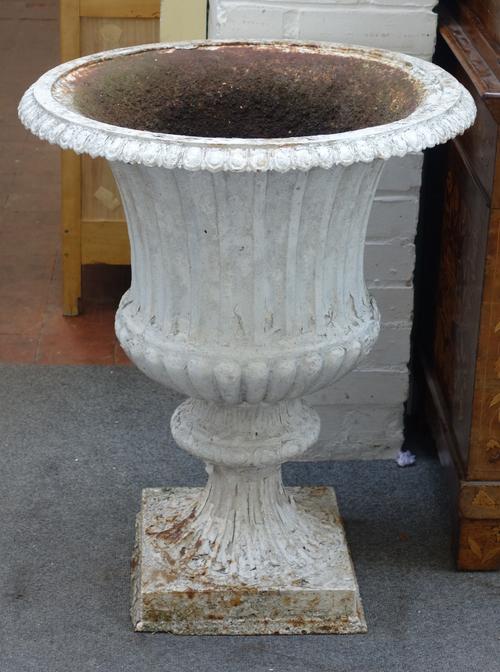 A Victorian white painted cast iron jardiniere with fluted semi bulbous body on square base, 64cm wide x 78cm high.