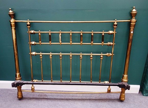 A Victorian brass double bed with turned decoration and urn finials, 157cm wide x 214cm long.