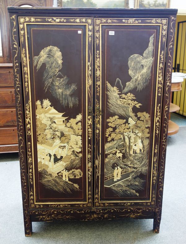 An early 19th century Chinese export black lacquer chinoiserie  decorated two door cupboard on block feet, 105cm wide x 166cm high x 48cm deep.