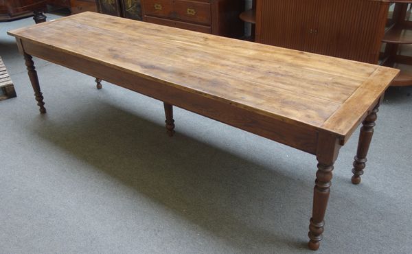 A 19th century French oak plank top kitchen table, with double end frieze drawer, on turned supports, 78cm wide x 268cm long x 74cm high.