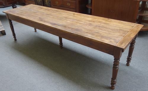 A 19th century French oak plank top kitchen table, with double end frieze drawer, on turned supports, 78cm wide x 268cm long x 74cm high.