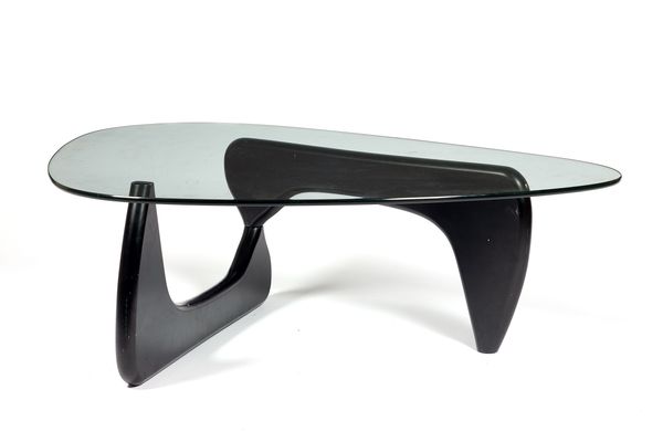 Isamu Noguchi for Herman Miller; a Noguchi coffee table, with shaped glass top on an ebonised base, 126cm wide x 39cm high x 94cm deep.  Illustrated