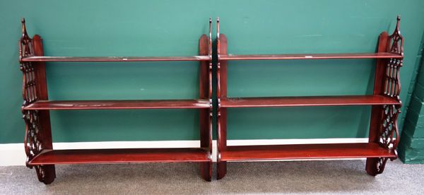 A pair of 18th century mahogany three tier hanging wall shelves, with pierced fret carved sides, 93cm wide x 22cm deep x 94cm high.