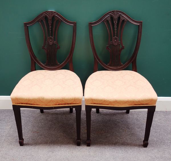 S & H Jewell, Little Queen St, Holborn, W.C; a set of eight George III style mahogany shield back dining chairs, each with serpentine seat, on taperin