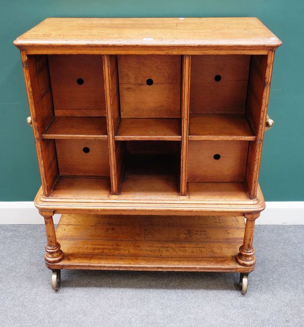 A Victorian oak floor standing cabinet with six large pigeon holes on turned supports, united by platform undertier, 94cm wide x 115cm high x 47cm dee