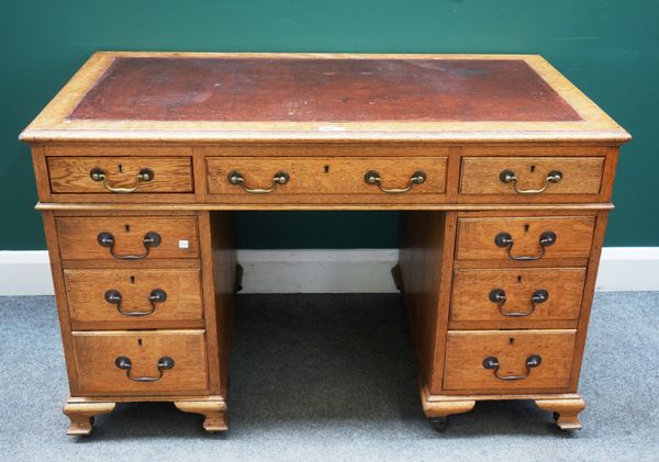 A Victorian oak pedestal desk with nine drawers about the knee, 123cm wide x 68cm deep x  77cm high.