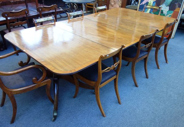 A George III and later satinwood banded twin pedestal extending dining table, on eight downswept supports, with two extra leaves, 149cm wide x 149cm l