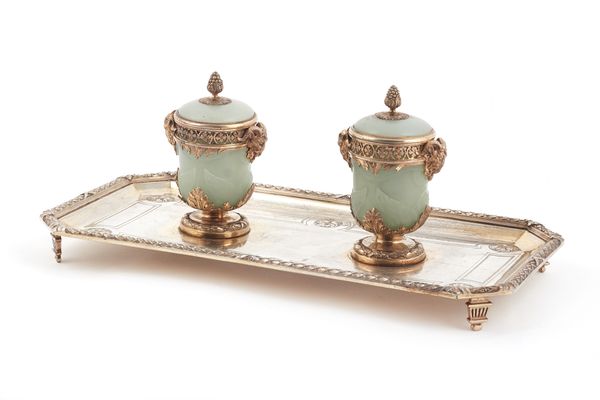 A French silver gilt and twin bottle pale green hardstone inkstand, the stand of cut cornered rectangular form, with cast borders and embossed foliate