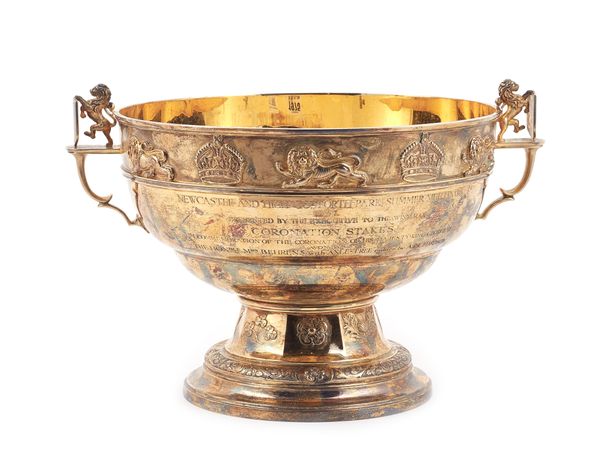 A George VI silver gilt twin handled trophy bowl, the border applied with cast lions and crowns, the plain body engraved with a presentation inscripti